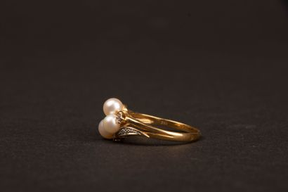 Gold ring set with three cultured pearls...