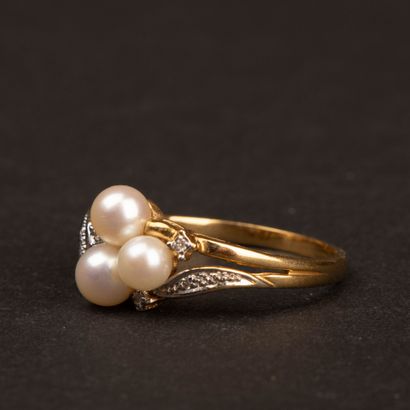 Gold ring set with three cultured pearls...