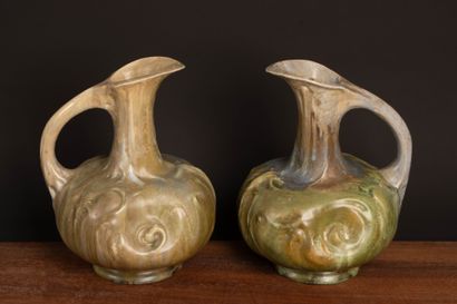 Pair of glazed stoneware pitchers.
Designed...