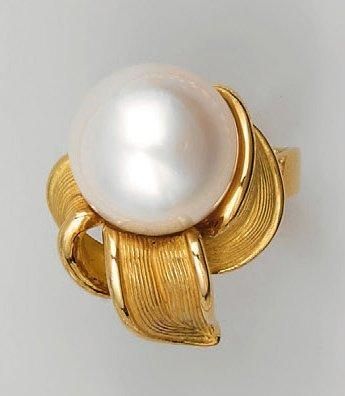 Bague en or jaune, ornée d'une perle de culture...