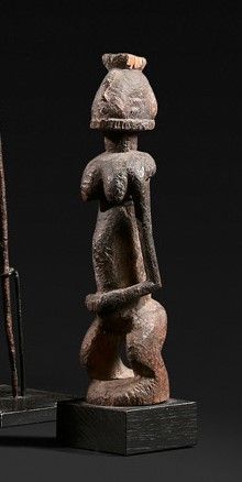 Standing figure in wood with old sooty patina.

Dogon....