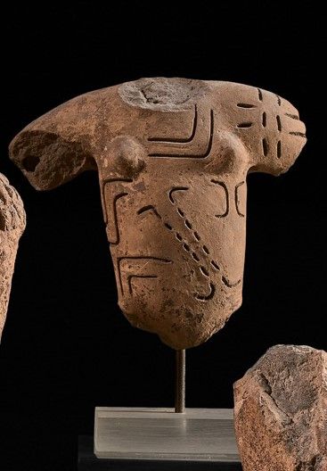 Acephalous bust covered with geometric scarifications....