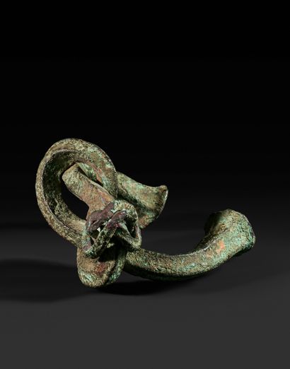 Currency in the shape of a knot. Copper with...