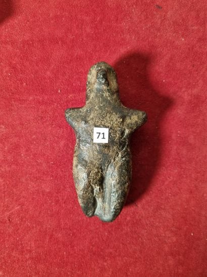 Stylized anthropomorphic votive statuette.

Black...
