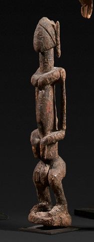 Standing figure in wood with old crusty patina.

Dogon....