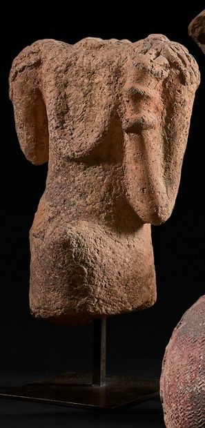 Acephalous bust of a woman with her left...
