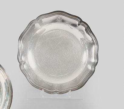 Round silver dish with five molded contours....