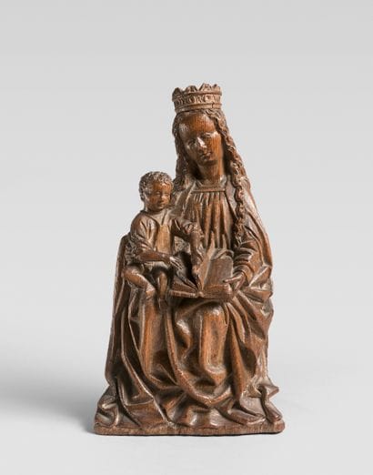 Carved oak Virgin and Child. Seated, the...