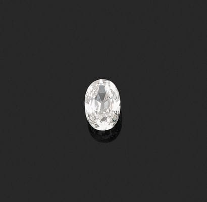 Oval old cut diamond on paper.
Accompanied...