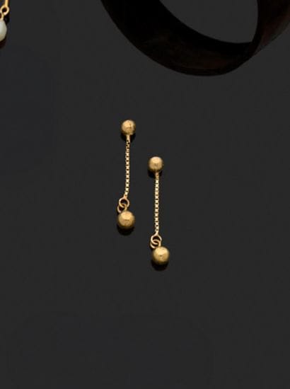 Paire de clous d’oreilles à pendant en or.
Poids...