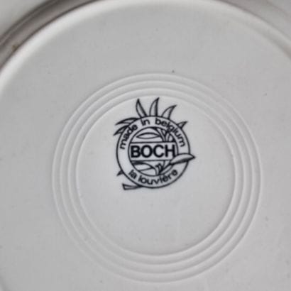 BOCH. Suite de 7 assiettes en faïence à décor...