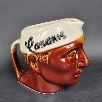 CASANIS. Pichet en faïence émaillée représentant...