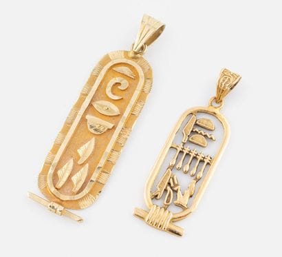 75- 2 Egyptian gold pendants. Weight: 7.55...
