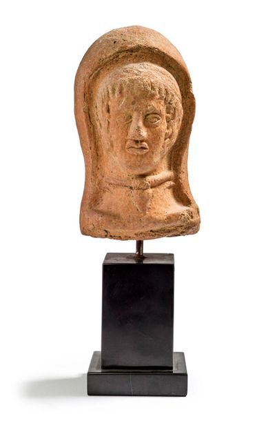 Male votive head in terracotta presented...