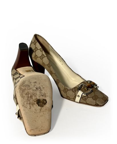 Gucci. Pair of leather and fabric pumps monogrammed...