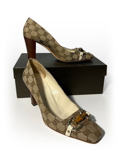 Gucci. Pair of leather and fabric pumps monogrammed...