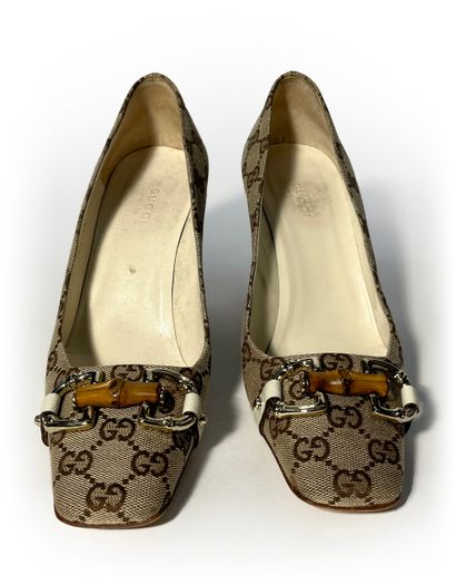 Gucci. Pair of leather and fabric pumps monogrammed...