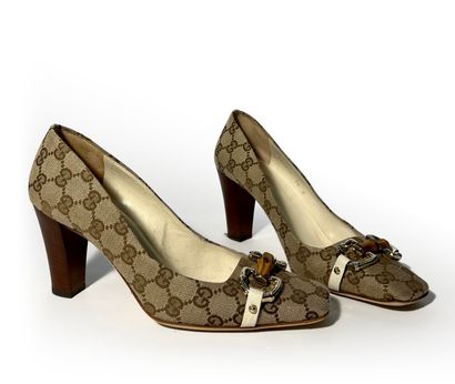 Gucci. Pair of leather and fabric pumps monogrammed...