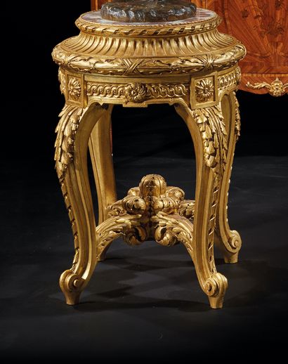 Gilded wood pedestal table decorated with...