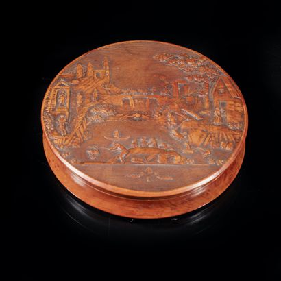 Circular boxwood box decorated with a lake...
