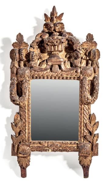 Petit miroir en bois sculpté et doré. Il...