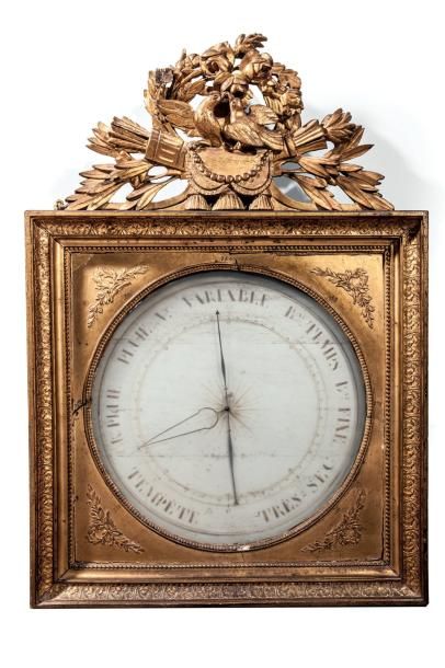 Baromètre en bois sculpté et stuc redorés....