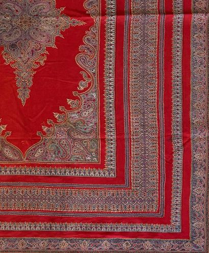 Tapis fond de laine rouge au médaillon central...