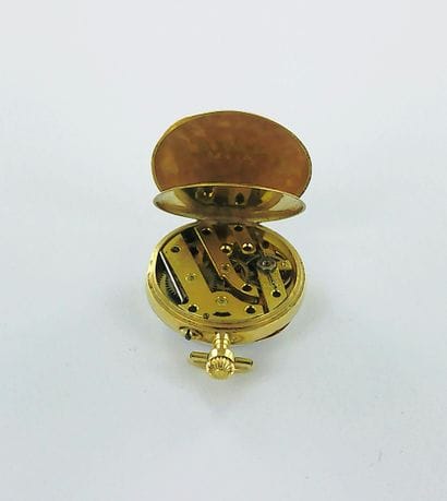 750-thousandths gold pocket watch with a...