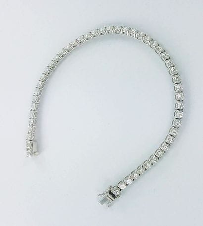 Bracelet ligne or gris 750 millièmes serti...