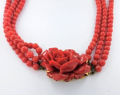 Three-strand coral necklace featuring a coral...