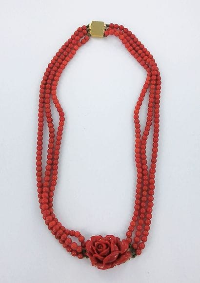 Three-strand coral necklace featuring a coral...