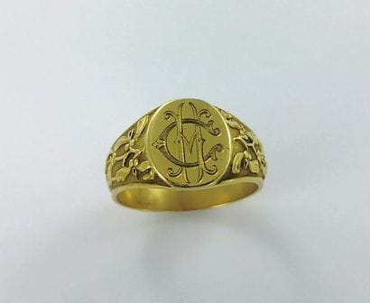 750-thousandths gold signet ring with a chased...