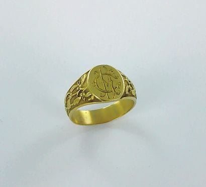 750-thousandths gold signet ring with a chased...
