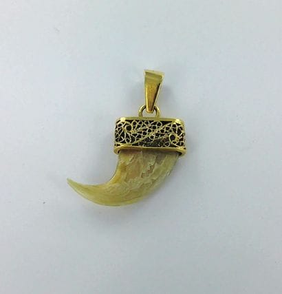 750-thousandths gold pendant featuring a...