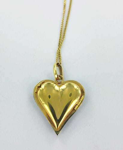 750-th gold heart medallion with enamel.
With...