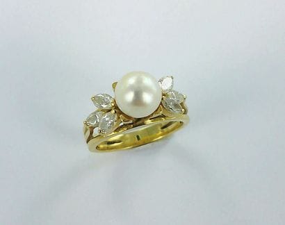 750-thousandths gold ring set with a pearl...