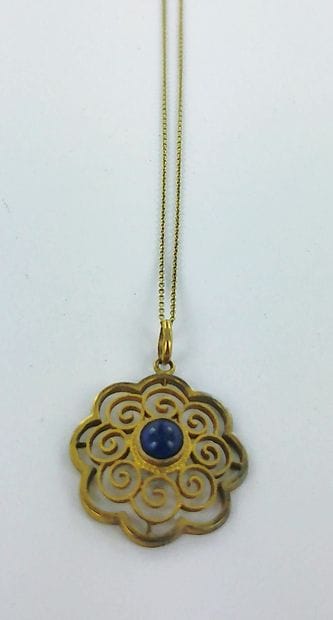 585-thousandths gold pendant set with a lapis...