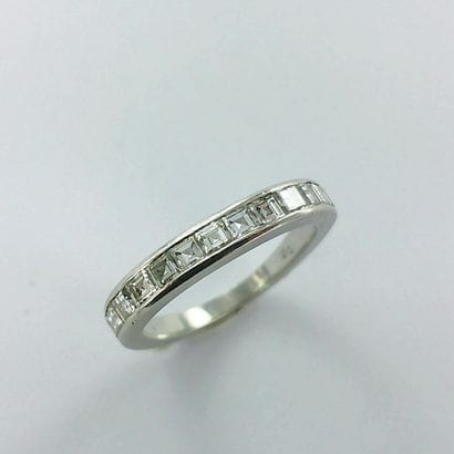 Platinum ring set with calibrated diamonds...
