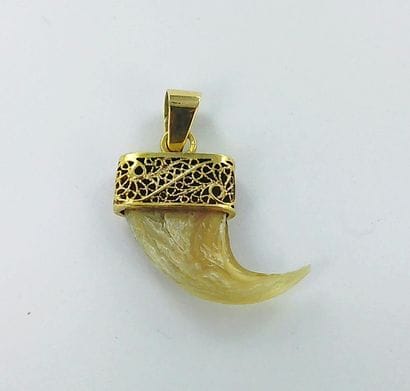 750-thousandths gold pendant featuring a...