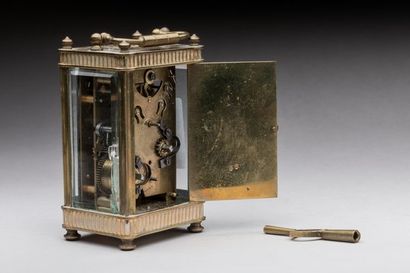 Travel alarm clock in brass and glass. 
19th...