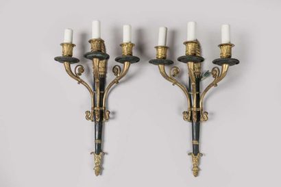 A brass and sheet metal chandelier with a...