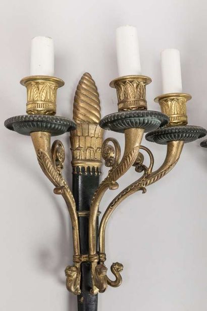 A brass and sheet metal chandelier with a...