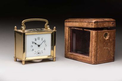 Brass travel clock in its leather case,
Ht...