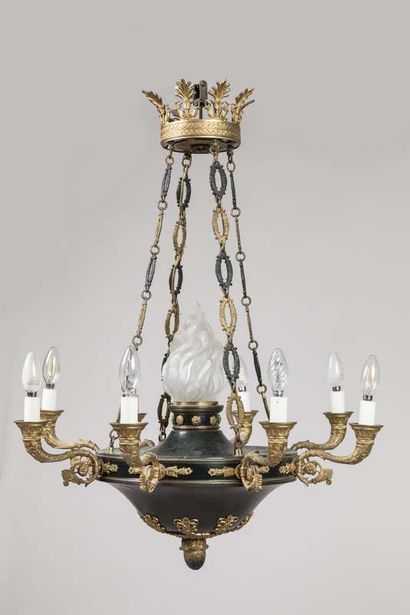 A brass and sheet metal chandelier with a...