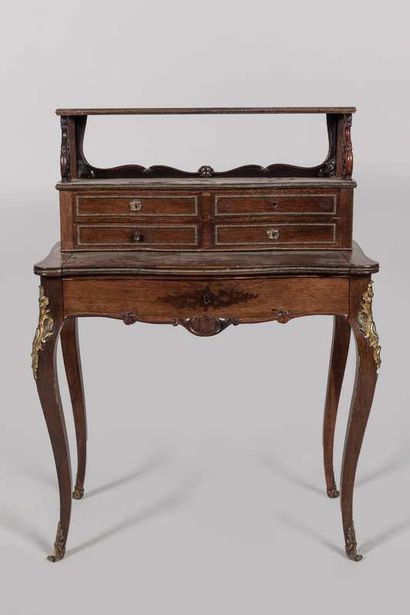 Desk in rosewood and rosewood veneer. It...