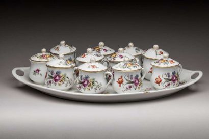 Eleven creamers and their tray in porcelain...