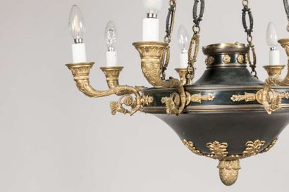 A brass and sheet metal chandelier with a...
