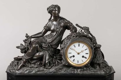 Black mantel set with a clock representing...