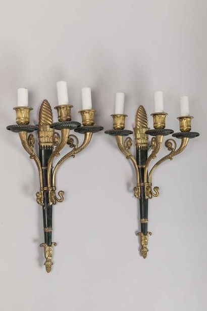 A brass and sheet metal chandelier with a...