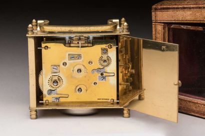 Brass travel clock in its leather case,
Ht...